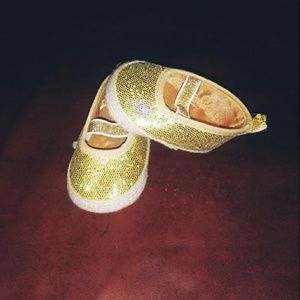 Gold baby shoes